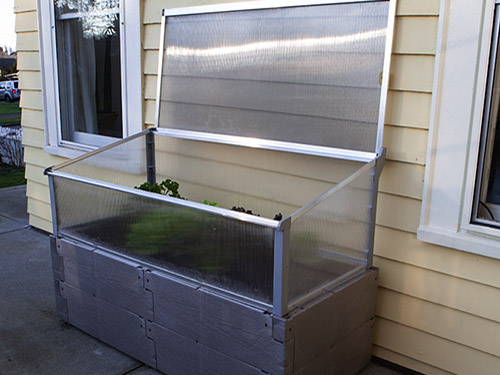 gray timber raised bed against house full open