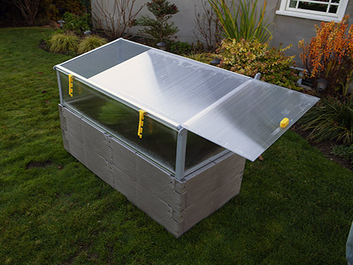 gray timber raised bed with cold frame sliding top panel